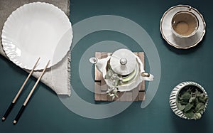 Empty white plate, chopsticks and herbal tea