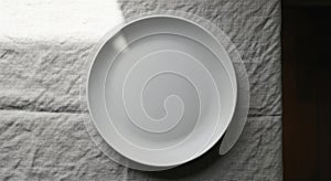 Empty White Plate on a Textured Gray Fabric Surface
