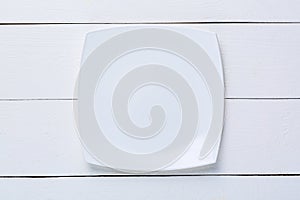 Empty white plate on white wooden table. Top view. Mockup for food project