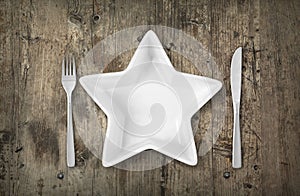 Empty white plate on a wooden