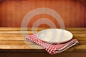 Empty white plate on wooden table