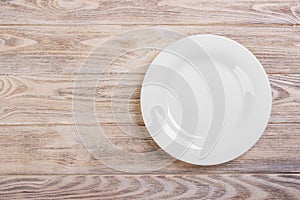 Empty white plate on wooden table. Template for your design