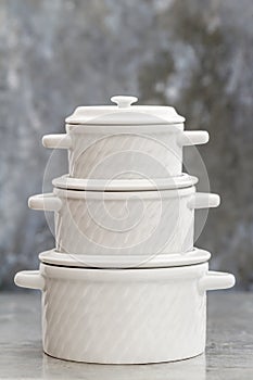 Empty White Porcelain Saucepans With Covers