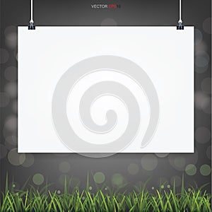 Empty white poster paper in green field area with light bluured bokeh in dark background. Vector