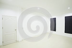 Empty white room with door and window