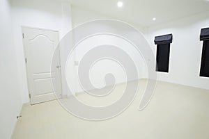Empty white room with door and window