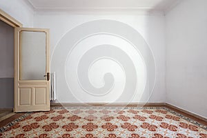 Empty, white room interior, tiled floor with floral decoration