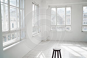 Empty white room with large windows