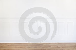 Empty white room with parquet floor and wood trimmed wall