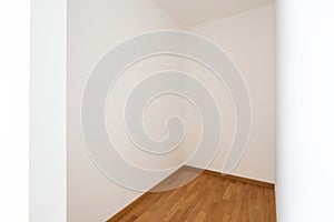 Empty white room with white walls and light parquet