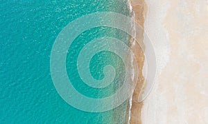 Empty white sand beach and calm turquise sea. Aerial view directly above