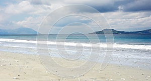 Empty white sand beach with little stones and clear blue ocean waves at Bajawa Ruting Flores. photo