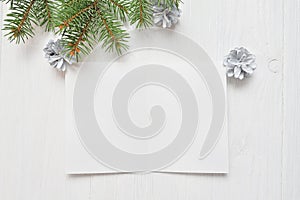 Empty white sheet of paper on a white Christmas background of fir branches and cones. Letter To Santa, mockup