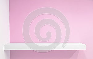 Empty white shop shelf, retail shelf on pink vintage background.