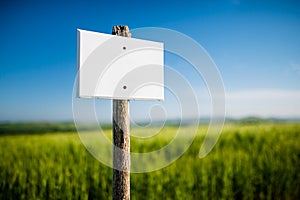 Empty white signboard with vintage wooden post and beautiful nature in the background