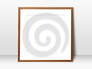 Empty white space in wooden blank frame leaning against wall