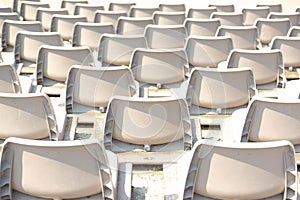 Empty white stadium stand rows with sunlight