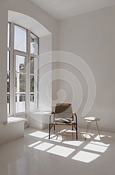 Empty white sunny room with wicker chair and table. Minimalist design