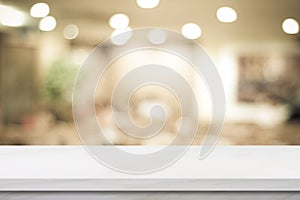 Empty white table top, counter, desk over blur perspective store with bokeh light background, White marble stone table, shelf and