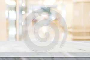 Empty white table top, counter, desk over blur perspective store with bokeh light background, White marble stone table, shelf and