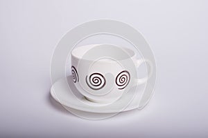 Empty white tea cup and saucer over white