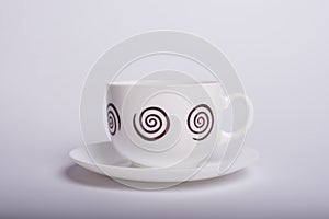 Empty white tea cup and saucer over white