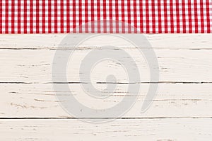 Empty white wood table background with vintage checked tablecloth