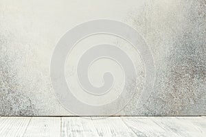 Empty white wooden table in front of stone wall