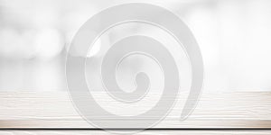 Empty white wooden table over blurred store with bokeh background banner, product display photo
