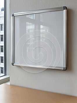 Empty whiteboard in a modern office setting.
