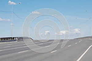 empty wide asphalt road under blue sky