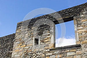 Empty window opening in an old stone wall