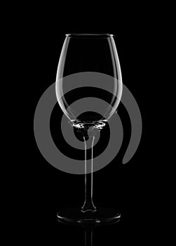 Empty wine glass on a black background.