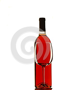 Empty wine glass and bottle of red wine