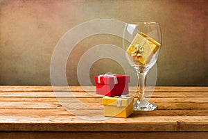 Empty wine glass with gift boxes