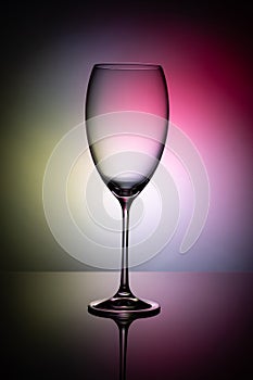 Empty wine glass goblets on a colored background abstract