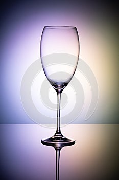 Empty wine glass goblets on a colored purple background  abstract