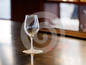 Empty wine glass on wooden bar counter, Kyoto, Japan