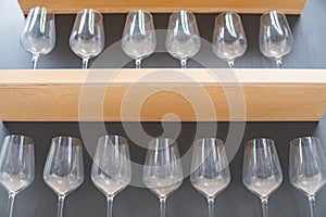 Empty wine glass on wooden rack in store