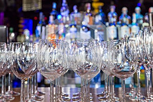 Empty wine glasses with color blur background in bar