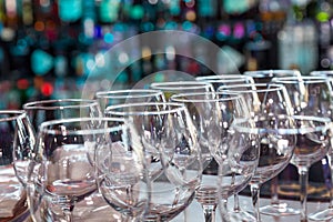 Empty wine glasses with color blur background in bar