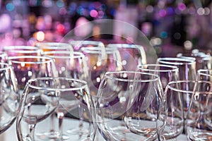 Empty wine glasses with color blur background in bar