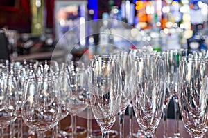 Empty wine glasses with color blur background in bar