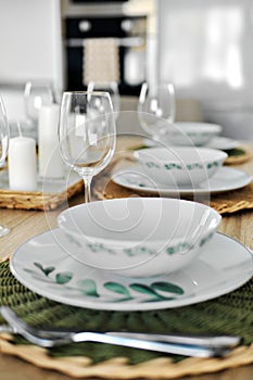 Empty wine glasses and dinnerware is ready for lunch