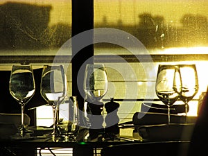 Empty wine glasses by a restaurant window
