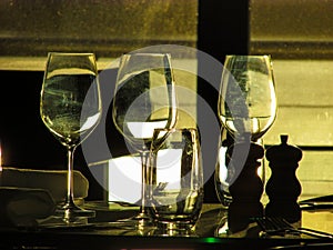 Empty wine glasses by a restaurant window