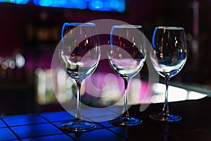 Empty wine glasses in row on bar or restaurant