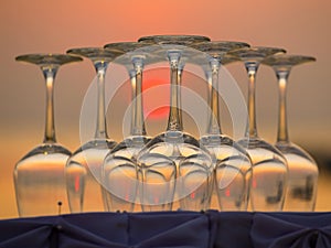 Empty wine glasses during sunset on the beach in a restaurant, Thailand