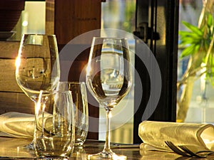 Empty wine glassess by a restaurant window