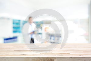 Empty wood counter top on blur pharmacy background